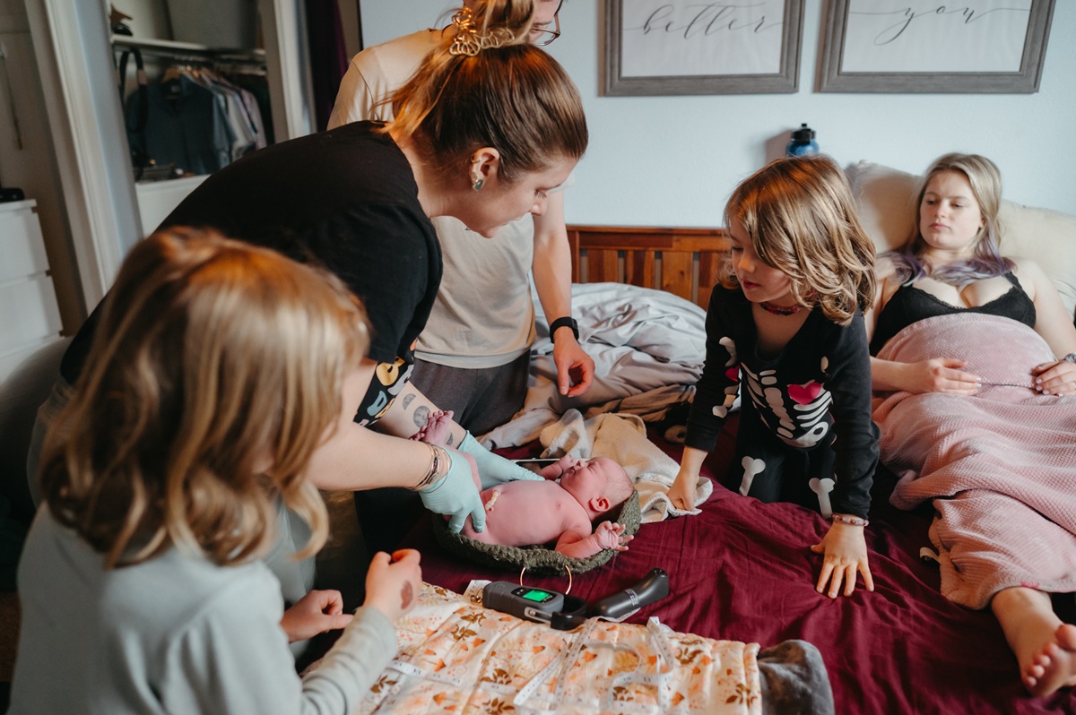 family gathered together, welcoming their newborn