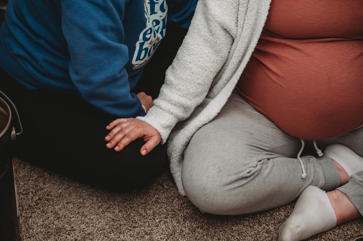 hands resting gently on a pregnant belly